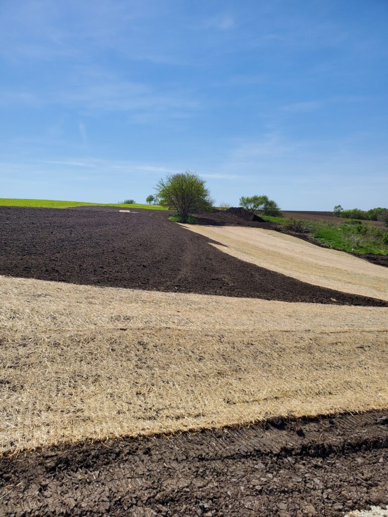 picture of a field with a straw blanket covering